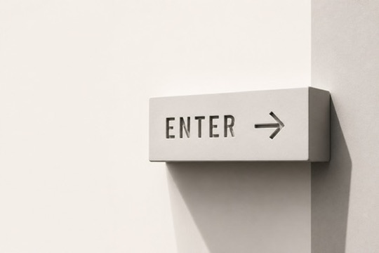 A concrete wayfinding sign reading ENTER with an arrow