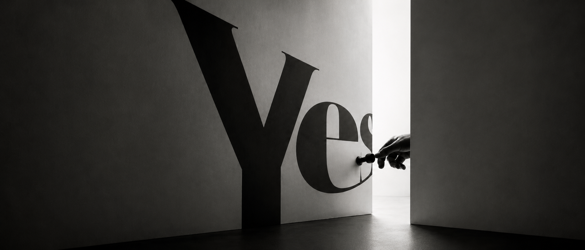 The word ‘Yes’ rendered as a wall a reaching hand is opening like a door.