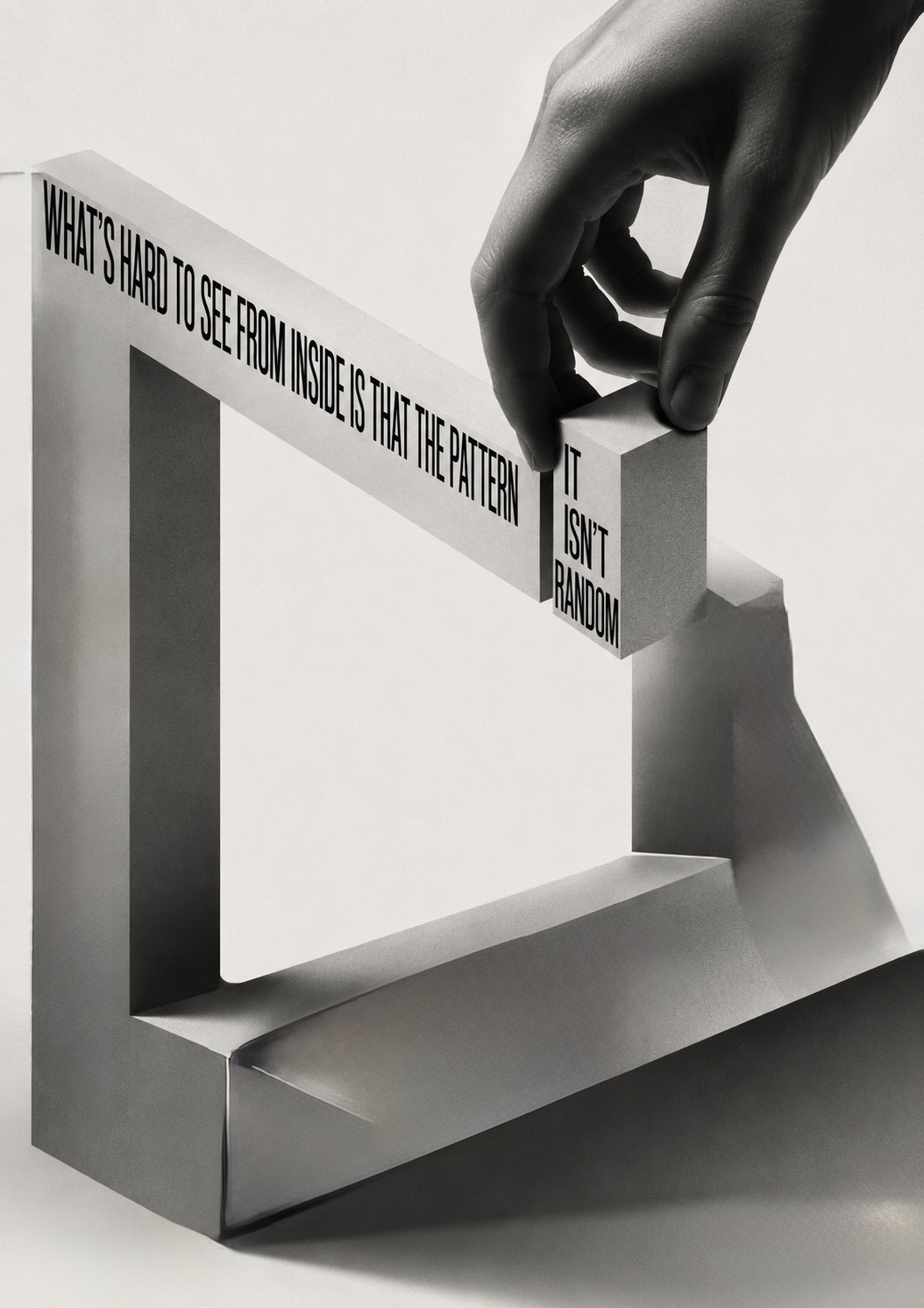 A hand lifting one block out of an impossible looping structure of type reading ‘what’s hard to see from inside is that the pattern — it isn’t random’ — a self-sustaining sequence with no clear beginning.