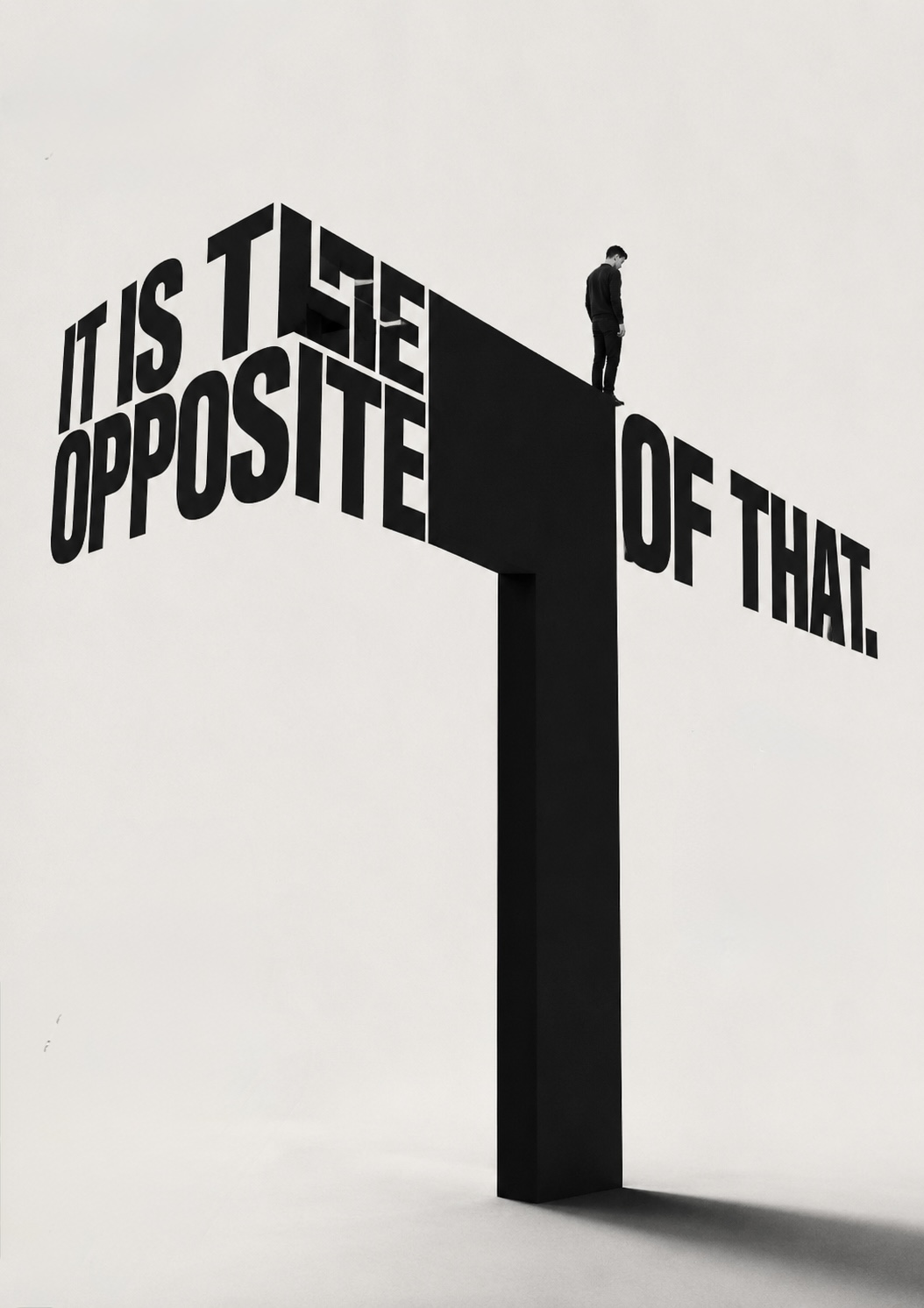Type poster reading &lsquo;IT IS THE OPPOSITE OF THAT&rsquo; in monumental block letters cantilevered from a single tall plinth, with a small figure standing at the edge looking down.