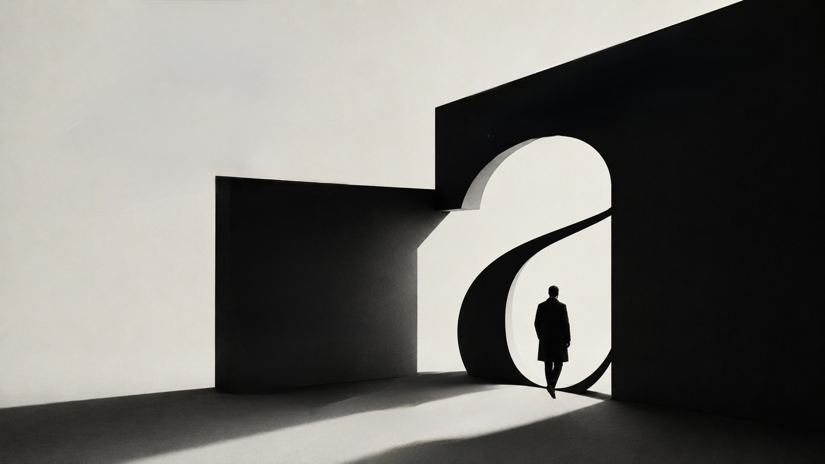 A lone figure walking through a curved archway of light into shadow, the negative space forming a lowercase &lsquo;a&rsquo;.